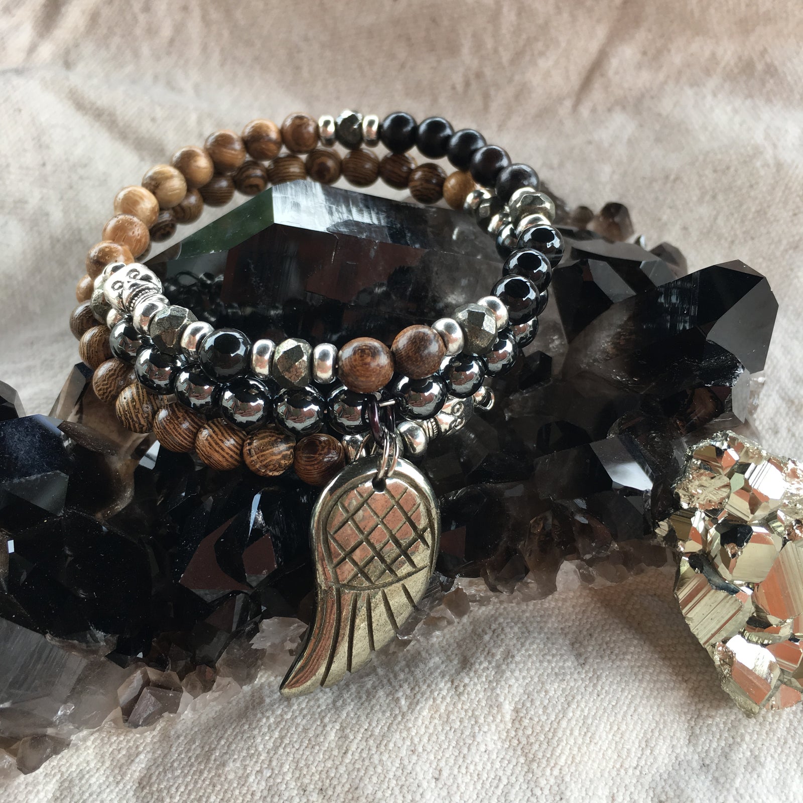 Rainbow Obsidian, Tiger Skin Sandalwood, Black Agate Dyed, Black Sandalwood, Agarwood, Hematite, Wenge Wood, and Pyrite Bracelet in Fibonacci Sequence with Pyrite Angel Wing